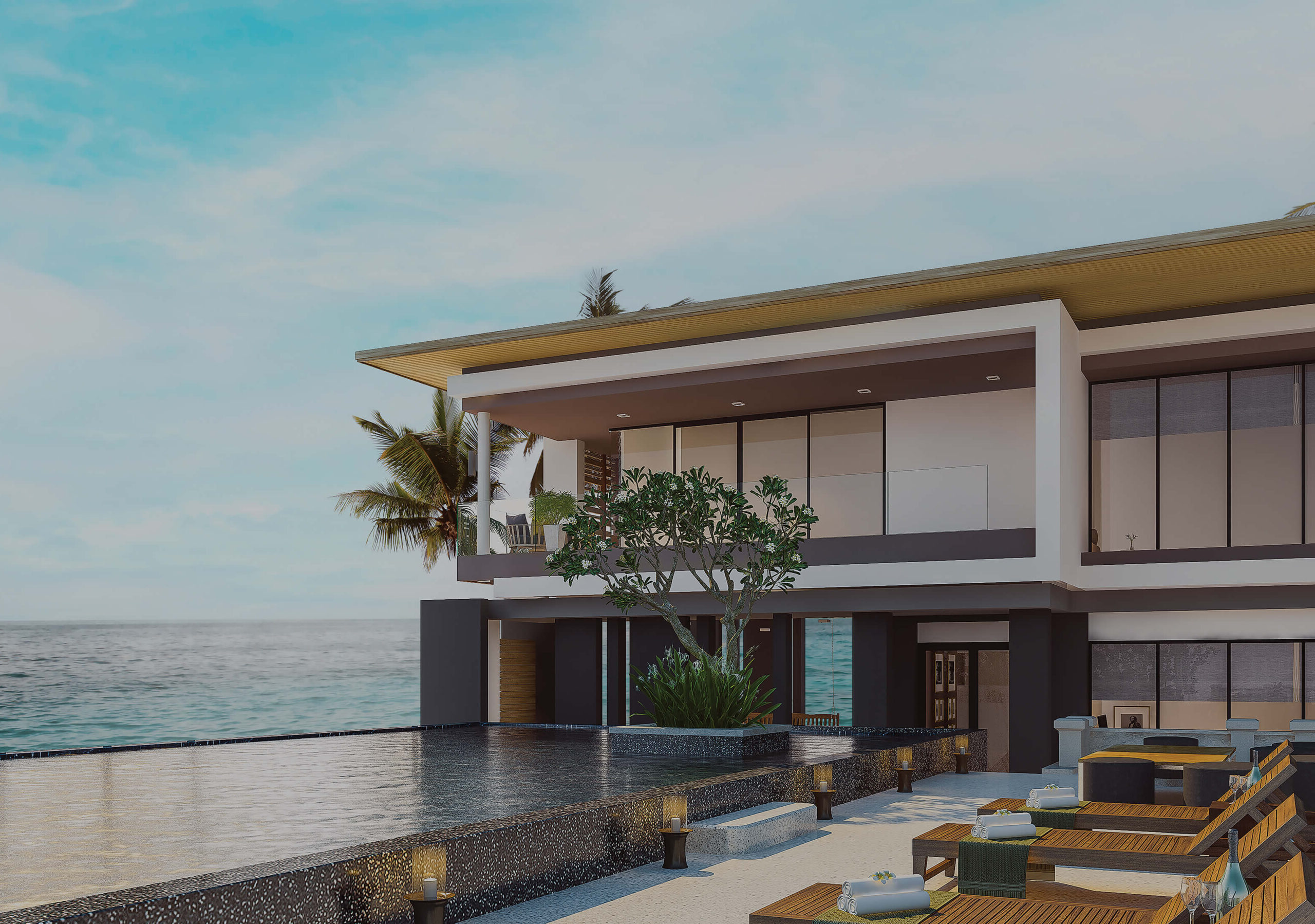 A contemporary beachfront villa with an expansive infinity pool, stylish architecture, and ocean views, surrounded by tropical greenery and palm trees.