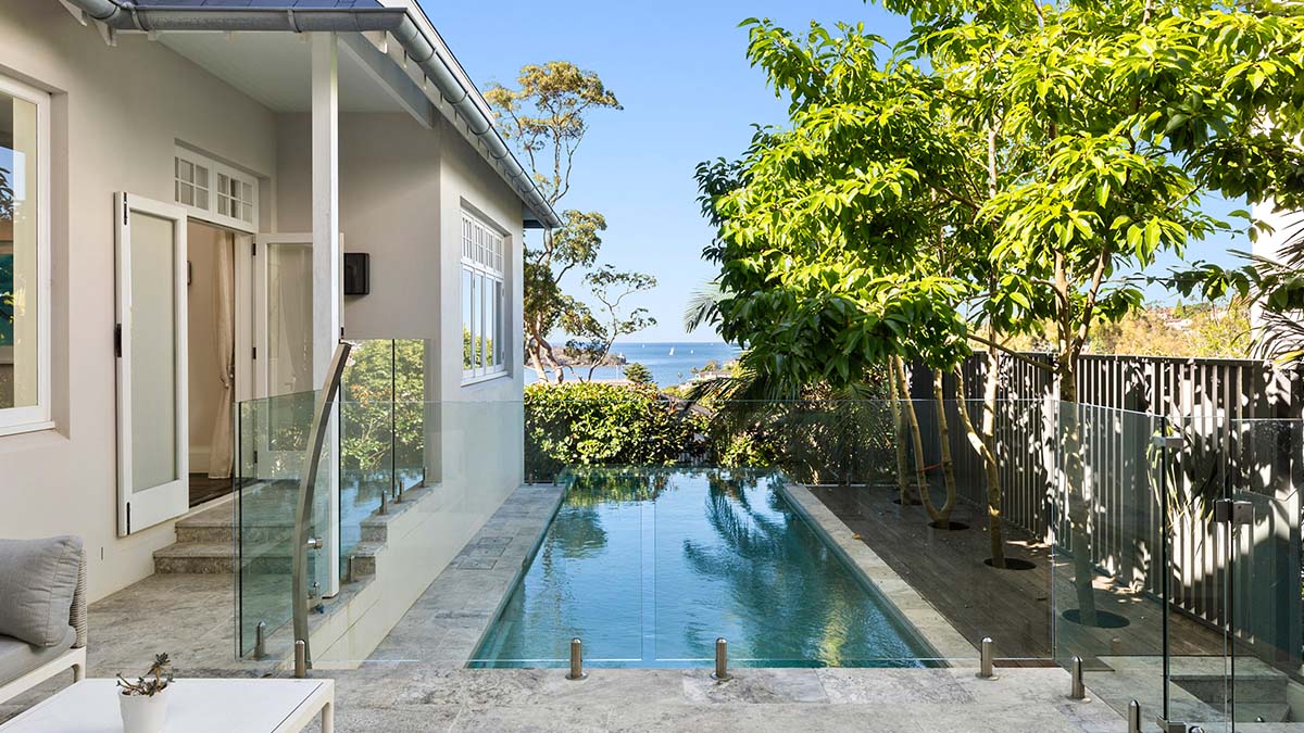Photo of a property with a pool, lush greenery and a view