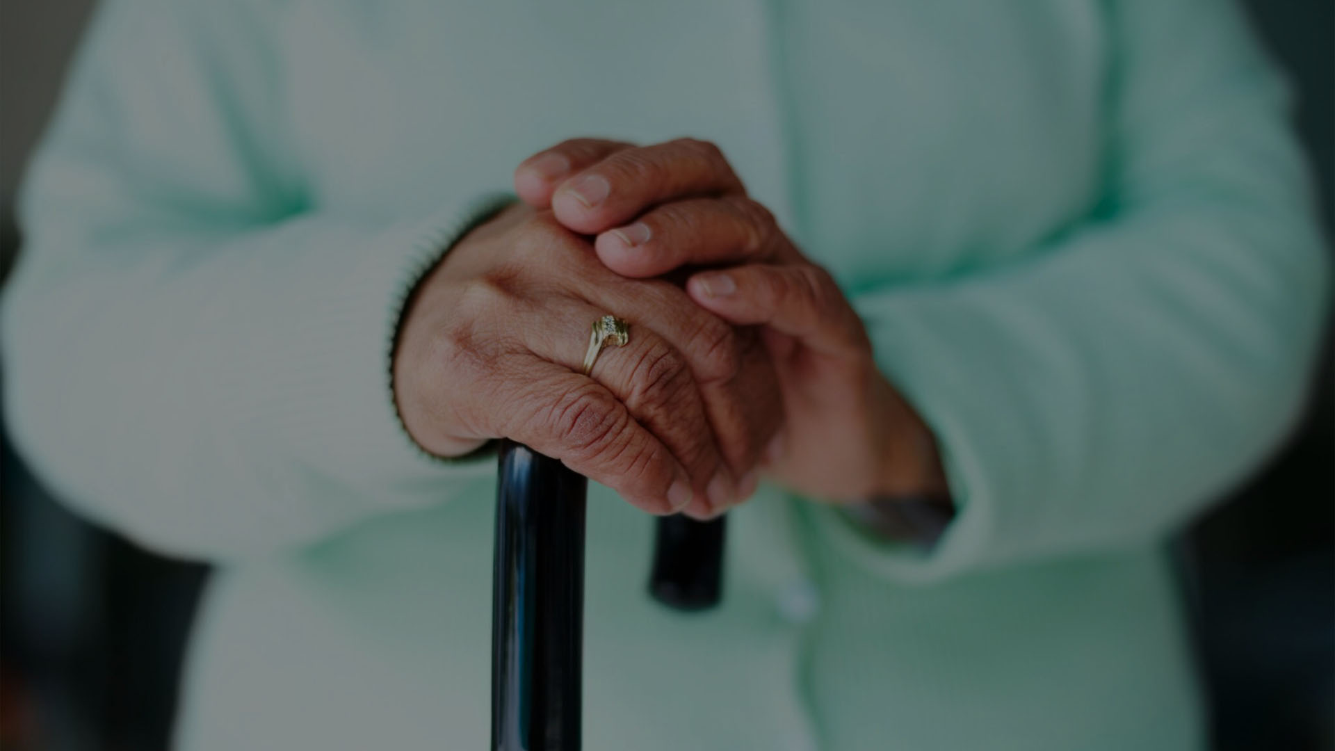 Photo of an elderly woman with a walking stick