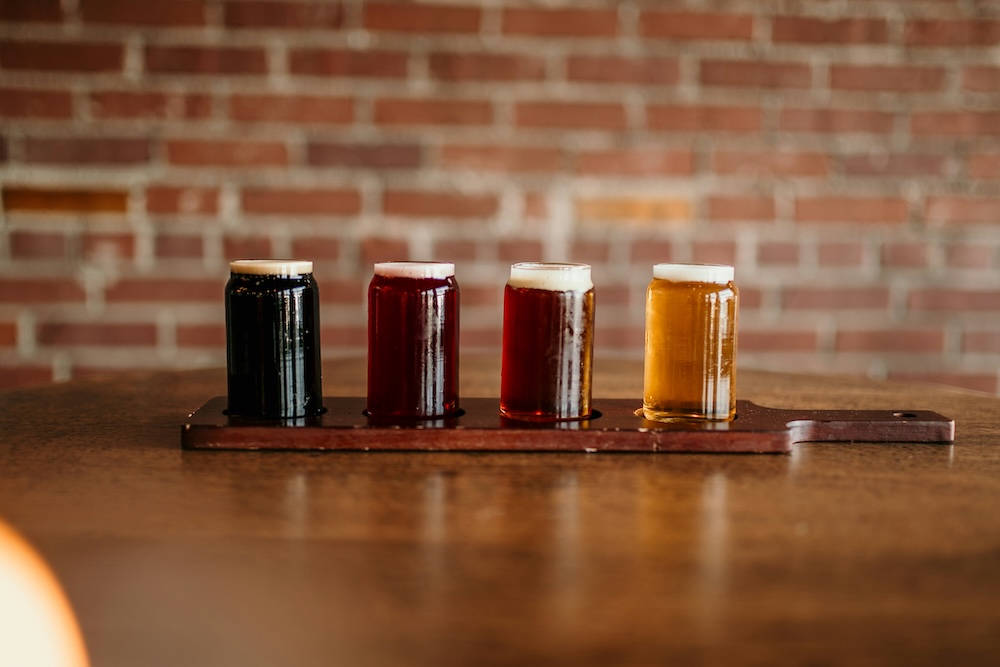 flight of beer at a craft brewery featuring a porter, a sour, an ale and a light lager