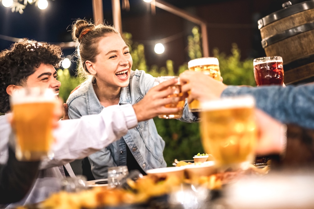 friends toasting drinks at a bar