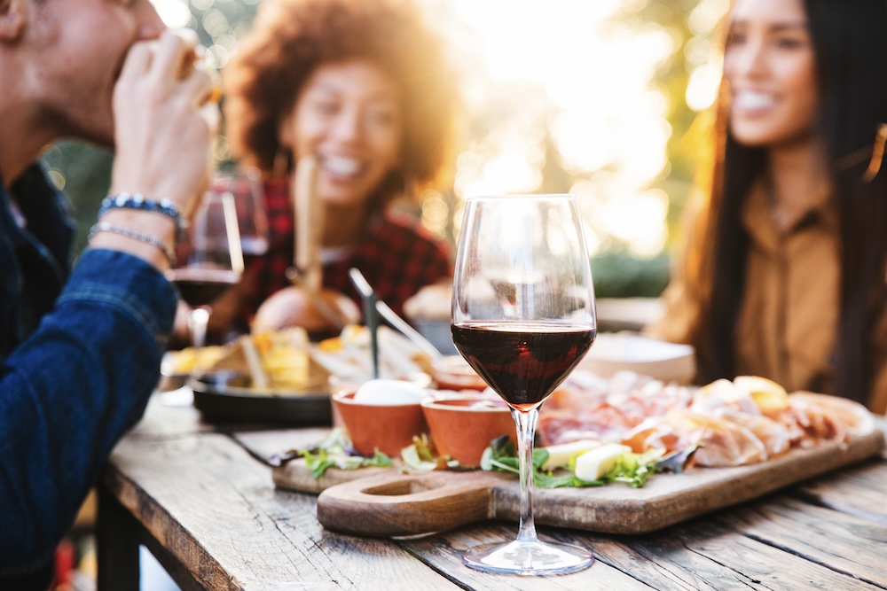 friends at an outdoor event enjoying dinner during the fall season