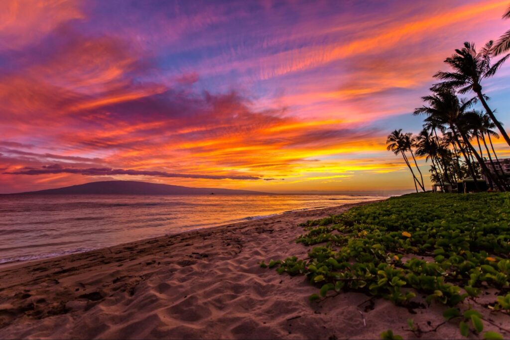 Stunning sunset over Kaʻanapali Beach with vibrant sky colors.