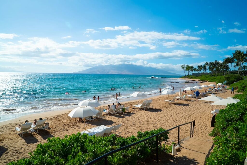 People relaxing and swimming at the beach in Maui on a sunny day