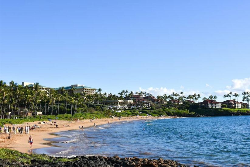 People walking along a beach in Wailea