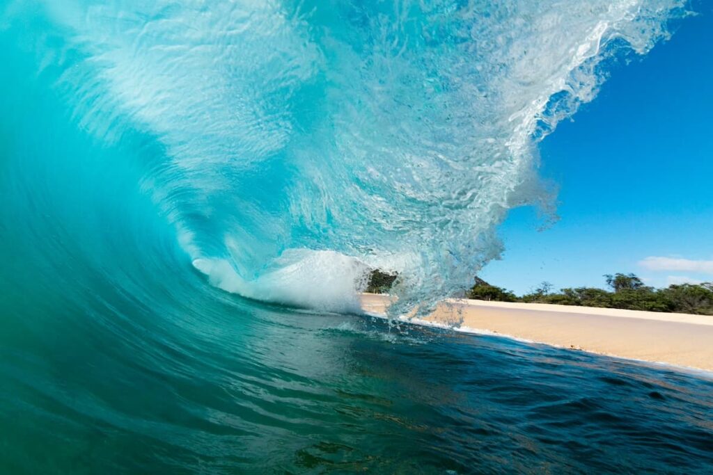 Large wave crashing onto the shore at Makena Beach in Maui