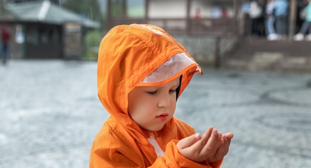 Child in orange rainsuit in Orange Beach, Alabama