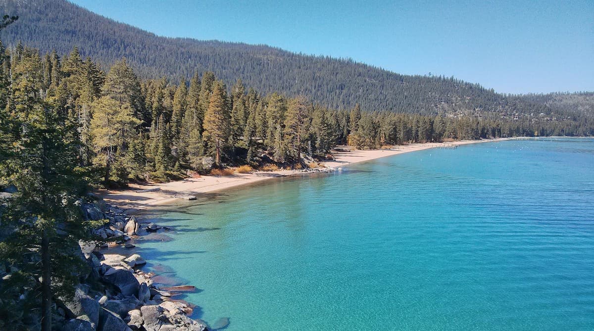 Clear blue waters at D.L. Bliss State Park with dense green forest in background