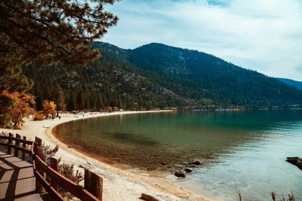 Shoreline at south lake tahoe with mountain in background and boardwalk to the left