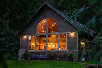 Mt. Baker cabin in the evening with warm lights on inside