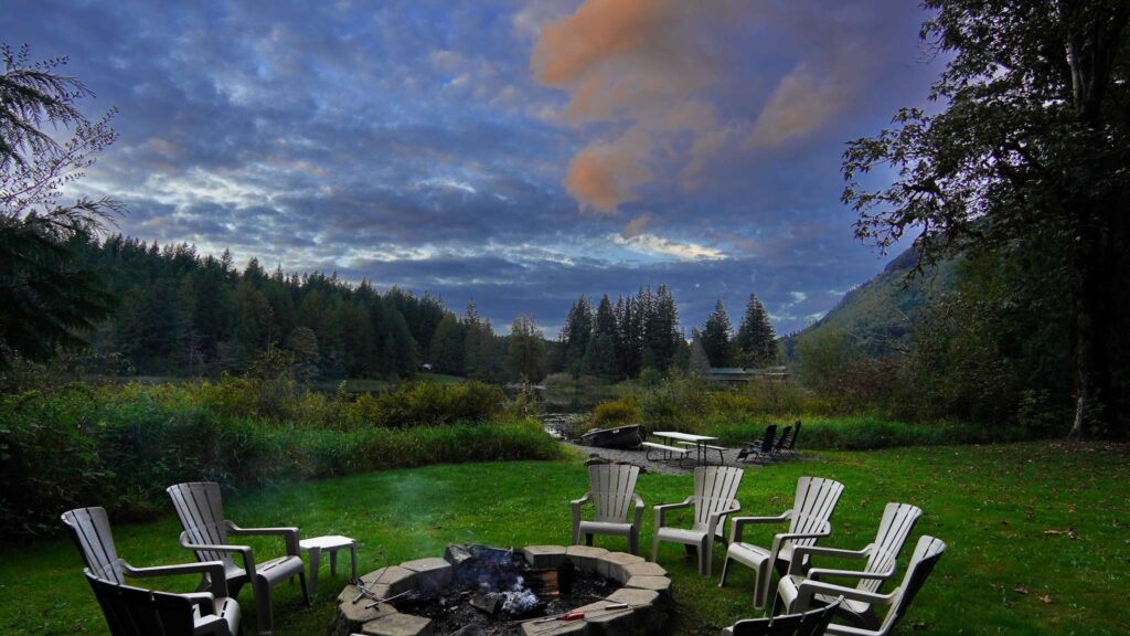 fire pit at dusk beside a lake in Mt. Baker