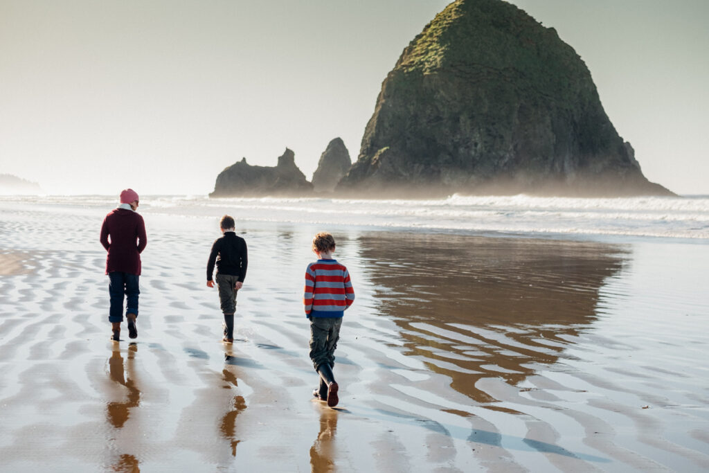 Kids walking on Cannon Beach - the most popular of all of Northern Oregon\'s beaches!