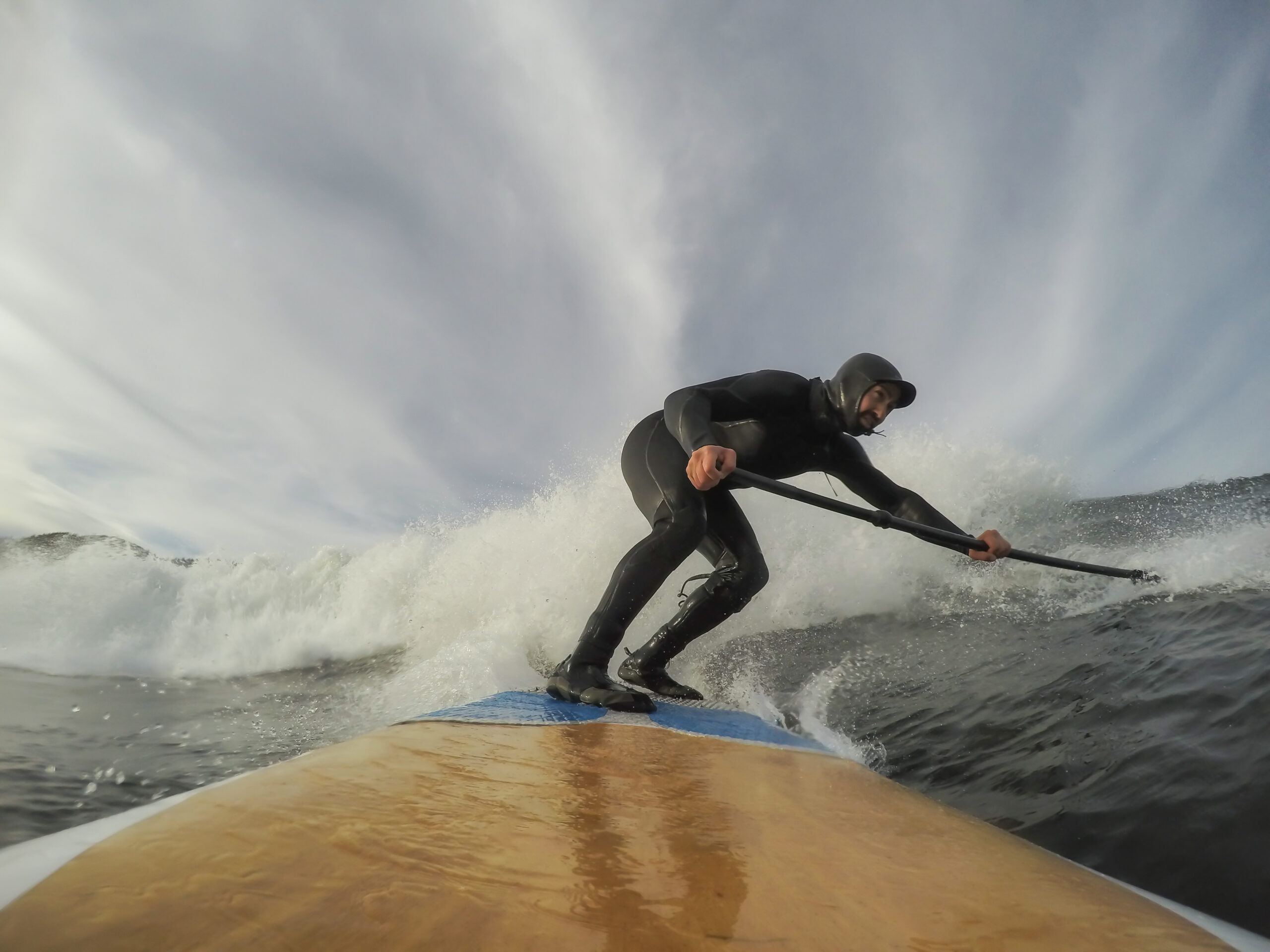 Man Paddle Boarding and Riding Waves