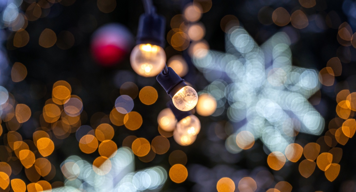 Festive Christmas lights bokeh with red ornaments and blue snowflakes representing holiday celebrations in Gearhart Oregon on the Northern Oregon Coast