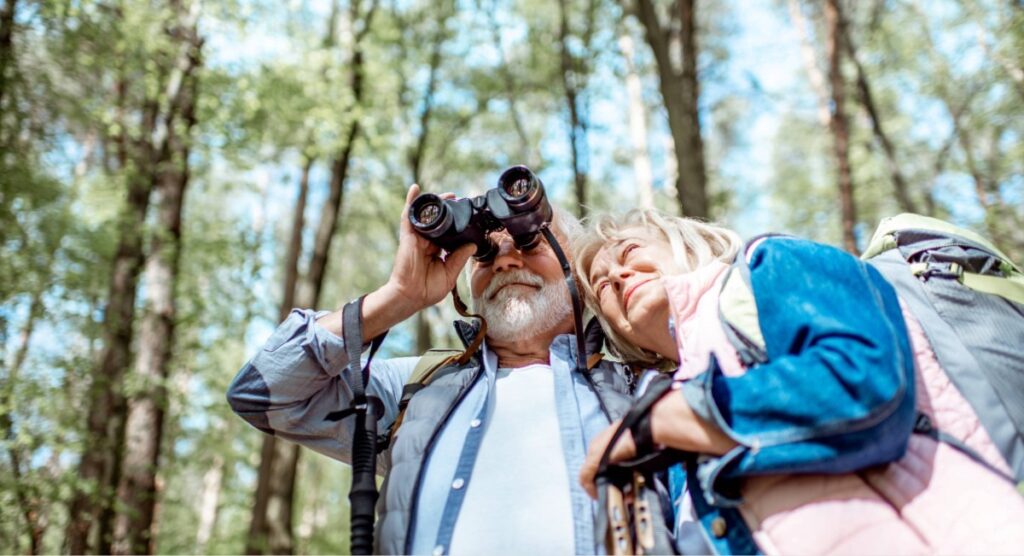 Senior couple birdwatching near Gearhart Oregon, accessible and low-effort outdoor activity on the Oregon Coast for older travelers