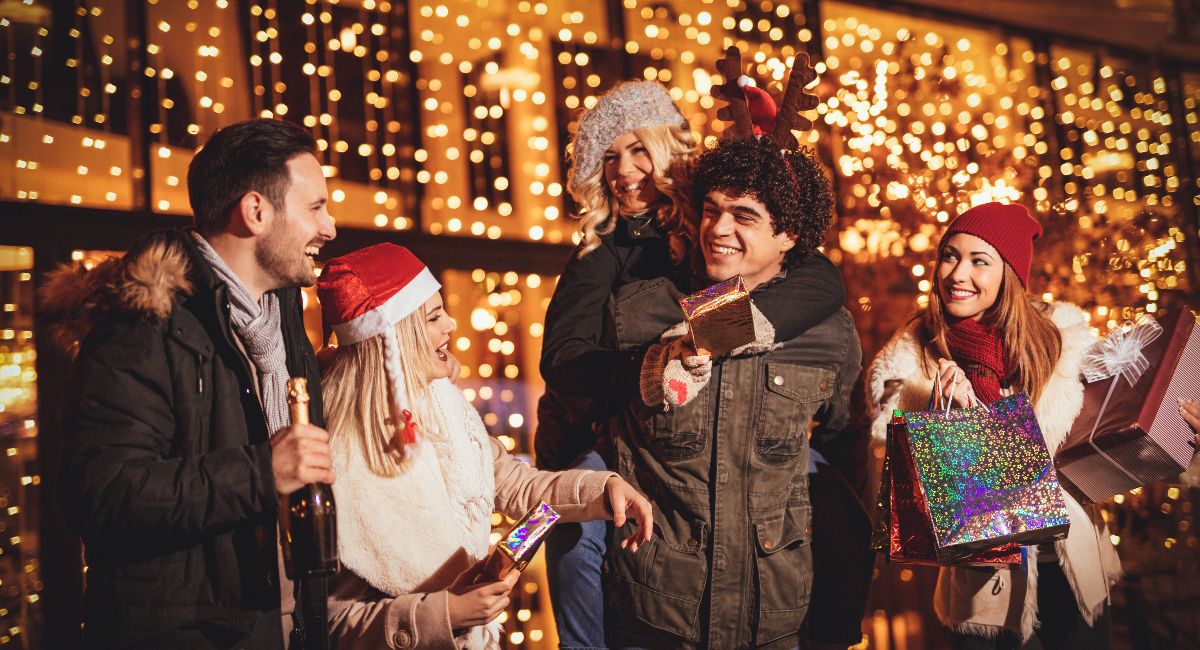 Friends celebrating Christmas in Pacific City, Oregon, with festive lights and holiday gifts, highlighting the magical atmosphere of the coastal town during the holiday season.