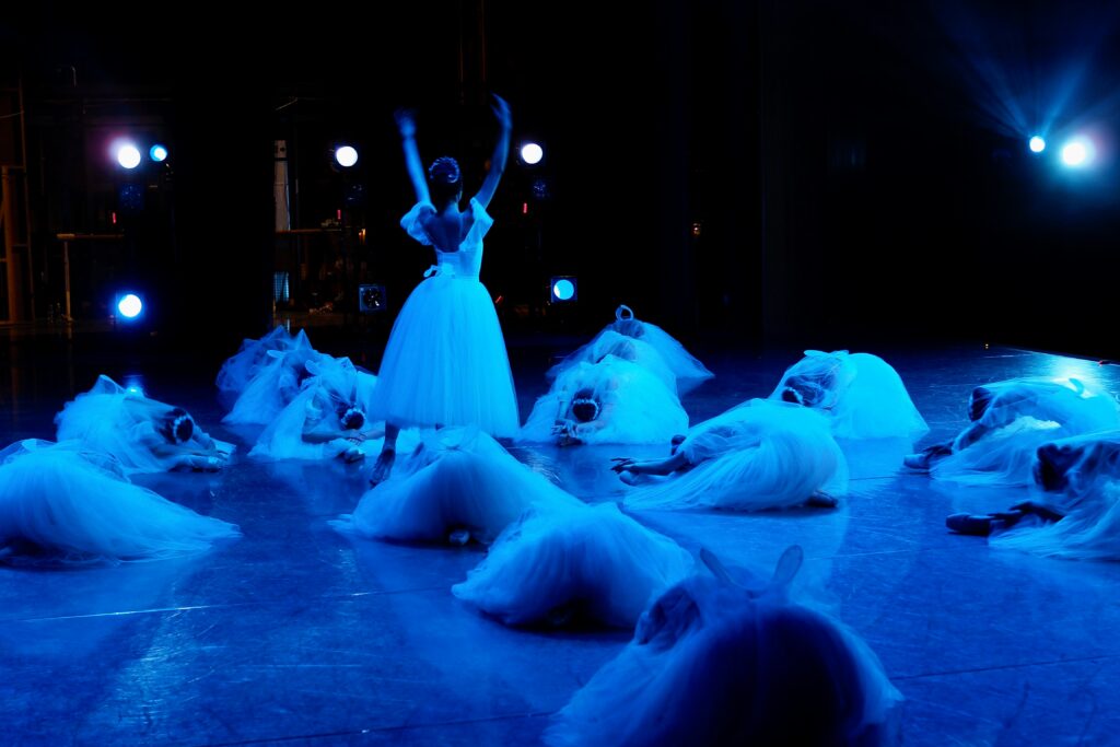 blue light on a stage during a ballet performace 