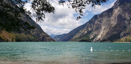 turquoise lake between mountain slopes