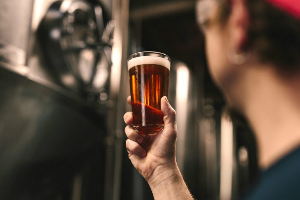 brewer holding up a glass of beer