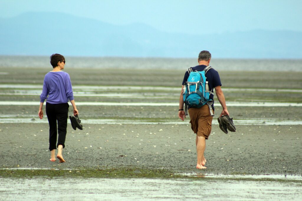 two people walking on rathtrevor beach in parksville bc