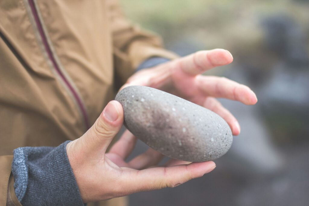 child's hands holding a rock