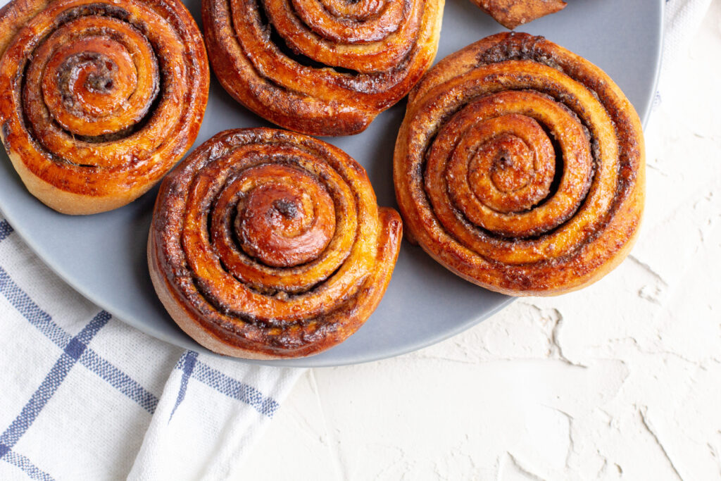 cinnamon buns on a white kitchen towel