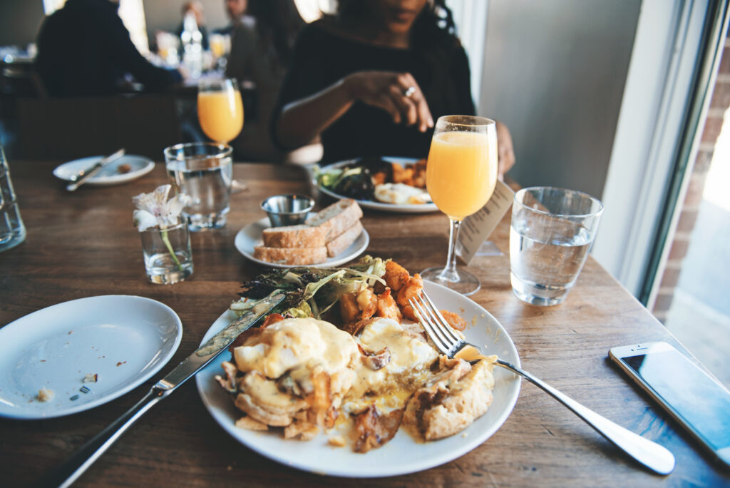 breakfast at a restaurant - eggs benny and mimosas