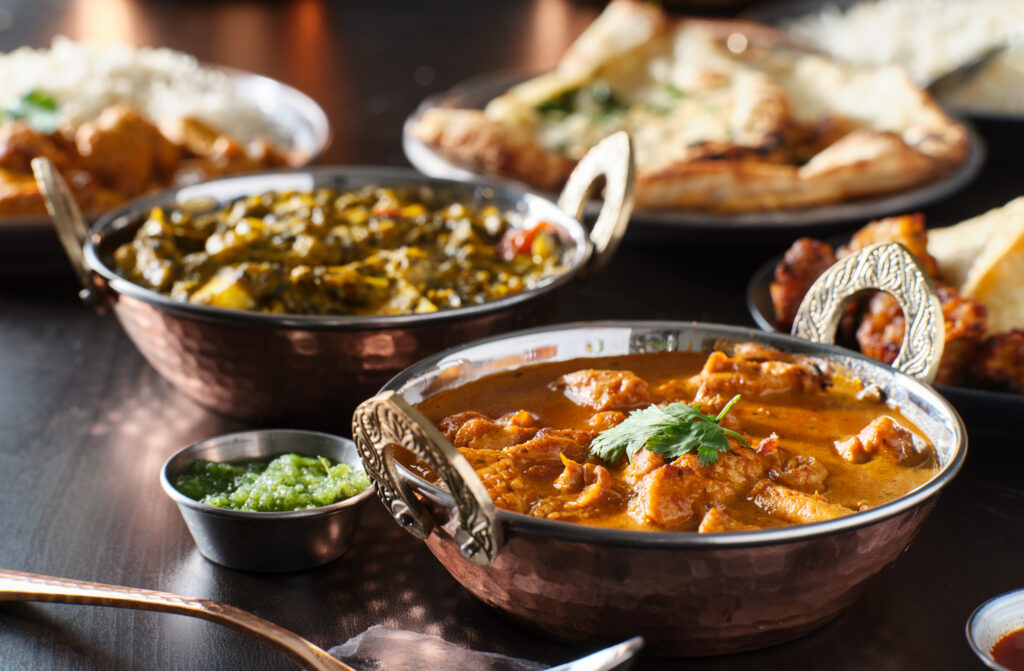 Indian dishes in metal bowls in a restaurant 