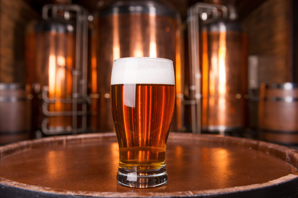 picture of a pint of beer in front of steel silos