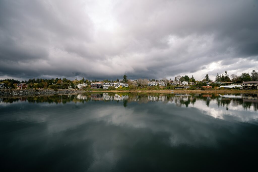 photo of a neighbourhood in Comox from the ocean - cloudy skies in Comox BC